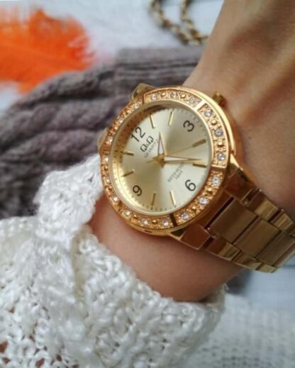 reloj qq color dorado para mujer con incrustaciones de cristales